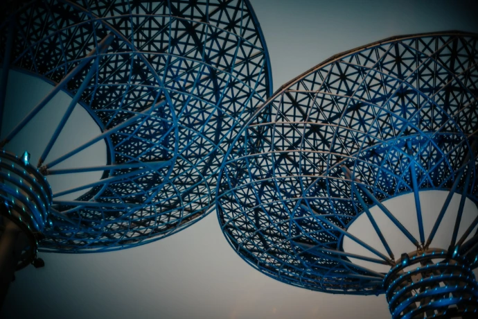 a close up of a metal structure with a sky in the background